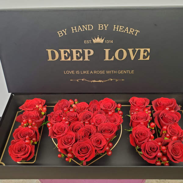 Red roses arranged in a gift box spelling "I LOVE U"
