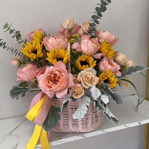 Pink and yellow flower basket with roses and sunflowers
