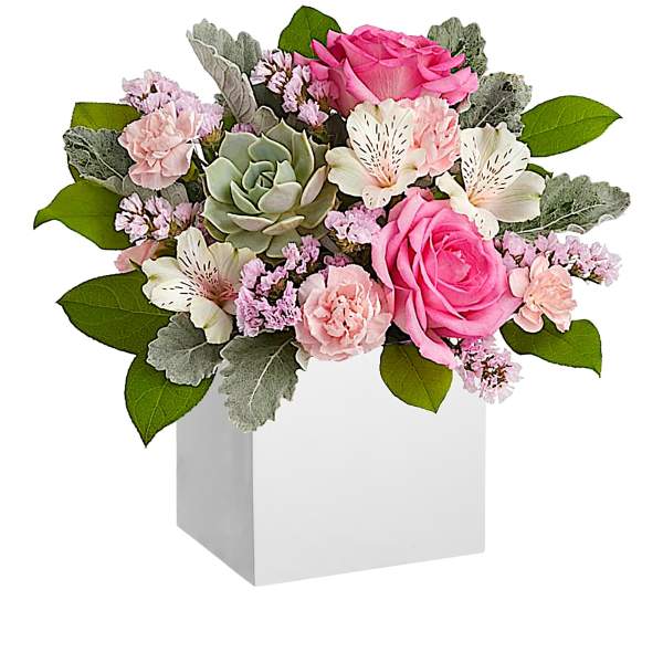 Pink and white floral arrangement in a white box with a succulent