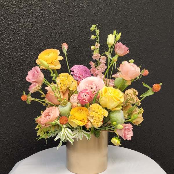 Mixed pastel bouquet in a gold cylinder vase