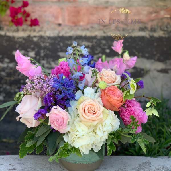 Colorful mixed bouquet in a low ceramic vase