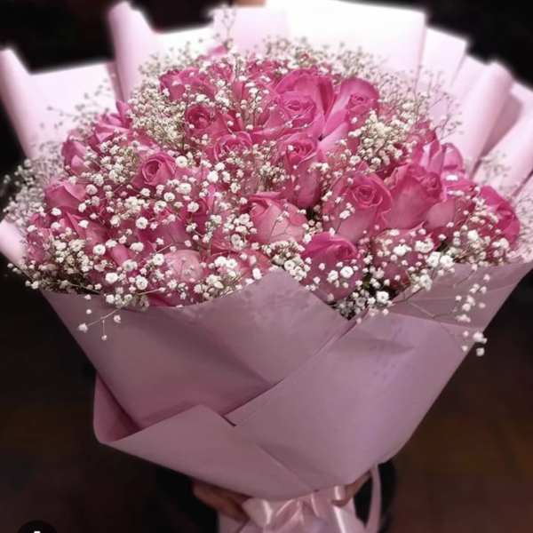 Pink rose bouquet with baby's breath wrapped in pink paper