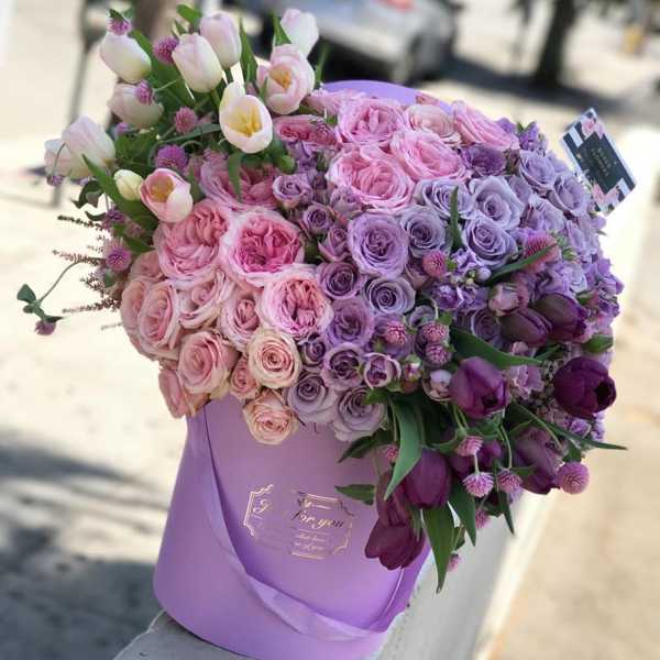 Lavender hatbox arrangement of pink and purple roses with tulips