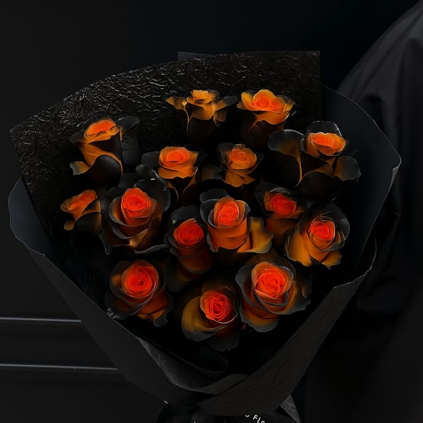 Bouquet of orange roses wrapped in black paper