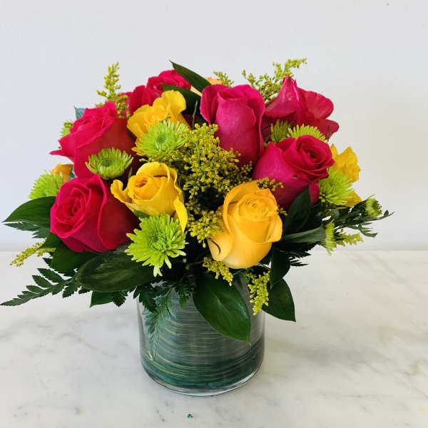 Bouquet of red and yellow roses in a glass vase