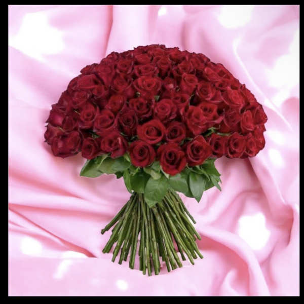 Bouquet of red roses on a pink satin background