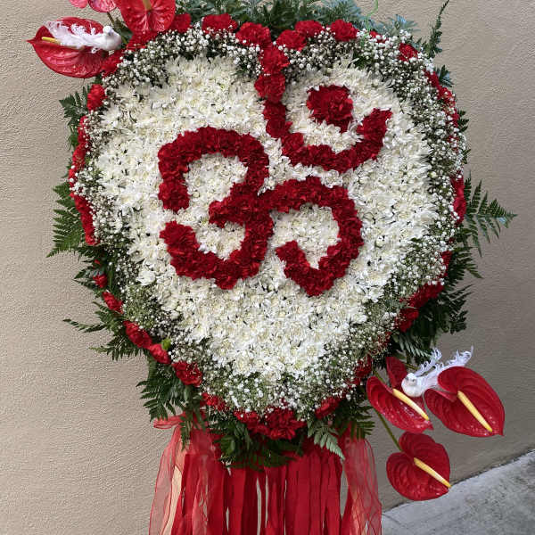 Heart-shaped floral standing spray with red and white flowers and red anthuriums