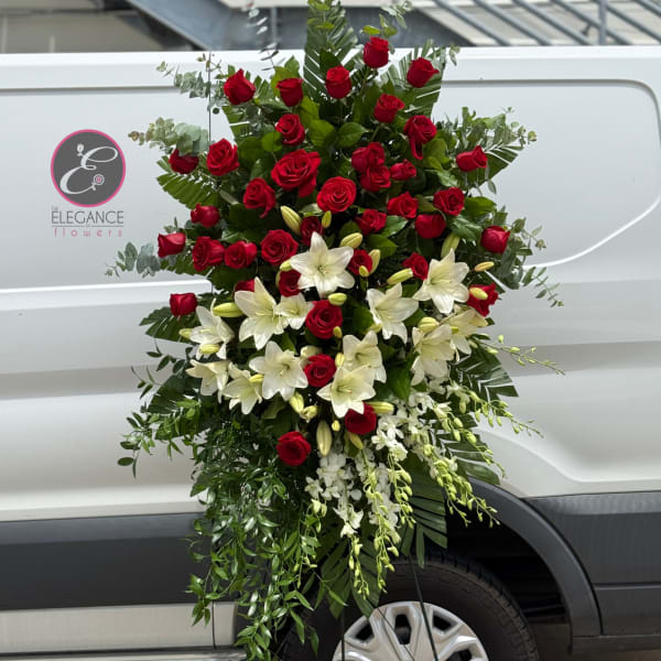 Tall standing floral spray with red roses and white lilies