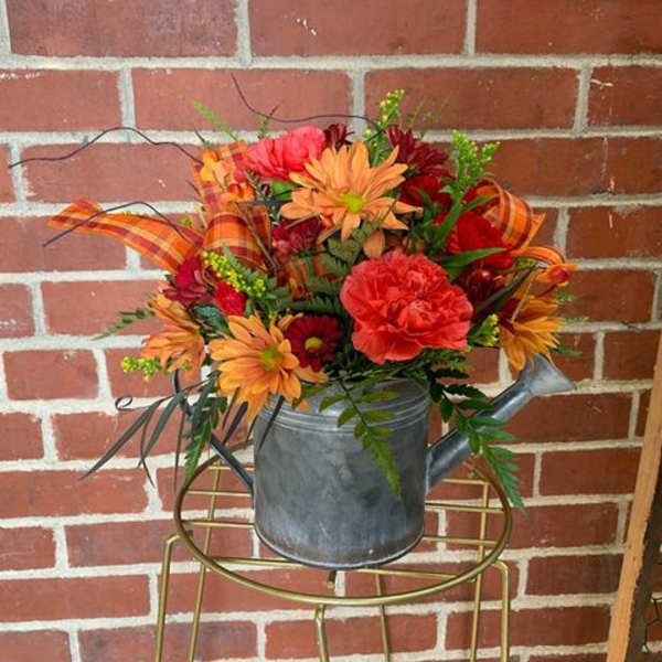 Fall flower arrangement in a metal watering can