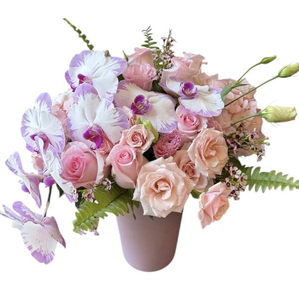Pink and lavender bouquet of roses and orchids in a vase
