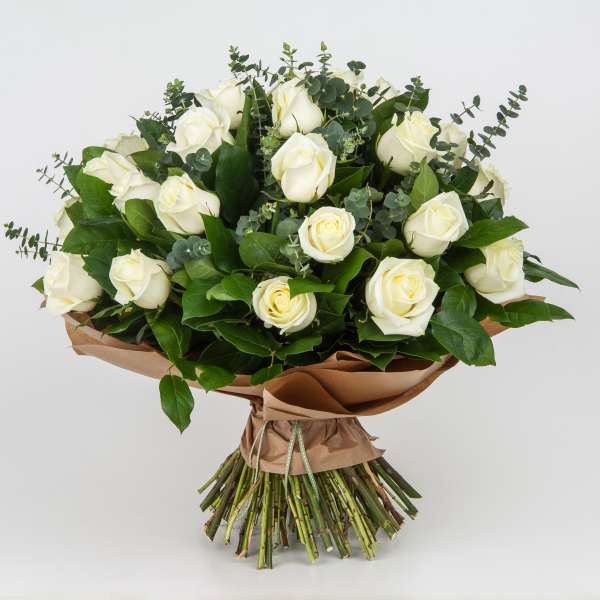 Bouquet of white roses with eucalyptus and brown paper wrap