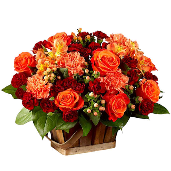 Orange and red flower arrangement in a wooden basket