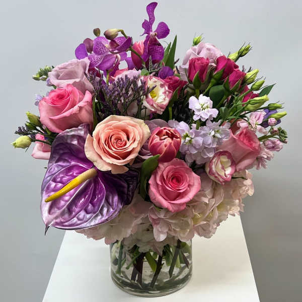 Pink and purple bouquet in a clear glass vase
