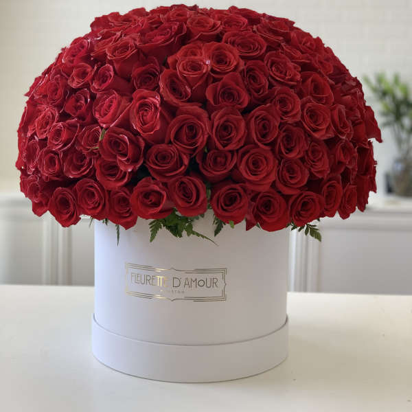 Large dome of red roses in a white hat box