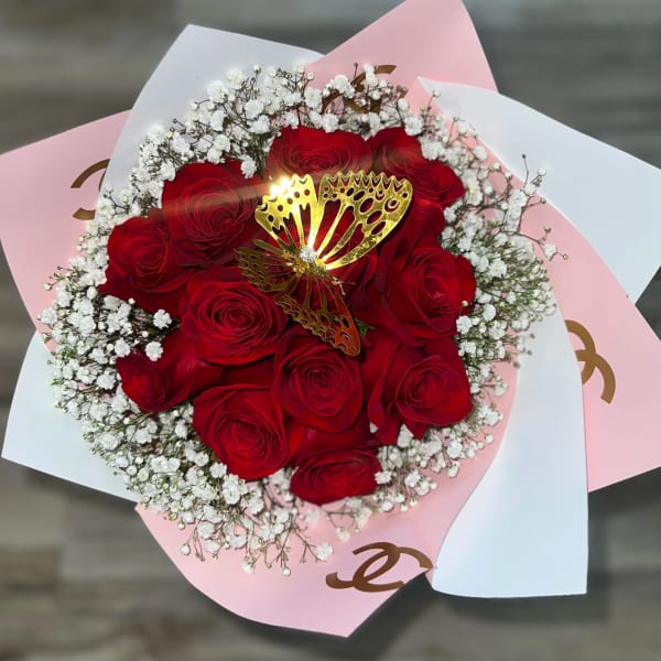 Bouquet of red roses with white baby's breath and a gold butterfly pick