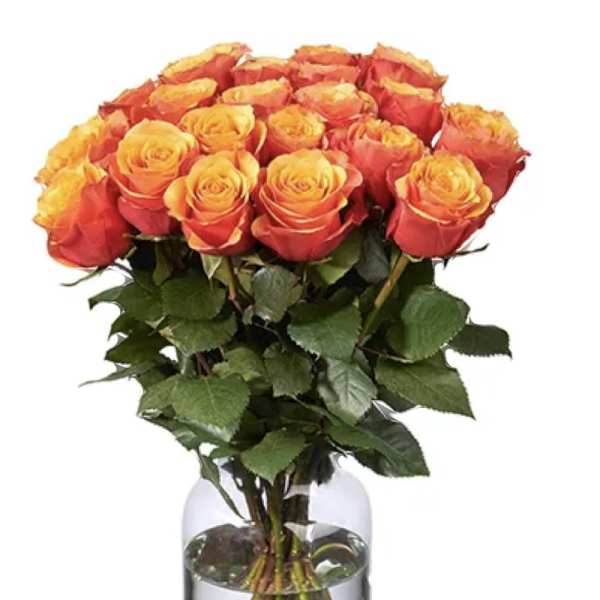 Bouquet of orange and yellow roses in a clear glass vase
