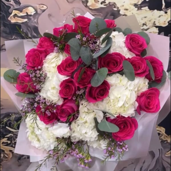 Bouquet of hot pink roses and white hydrangeas with eucalyptus