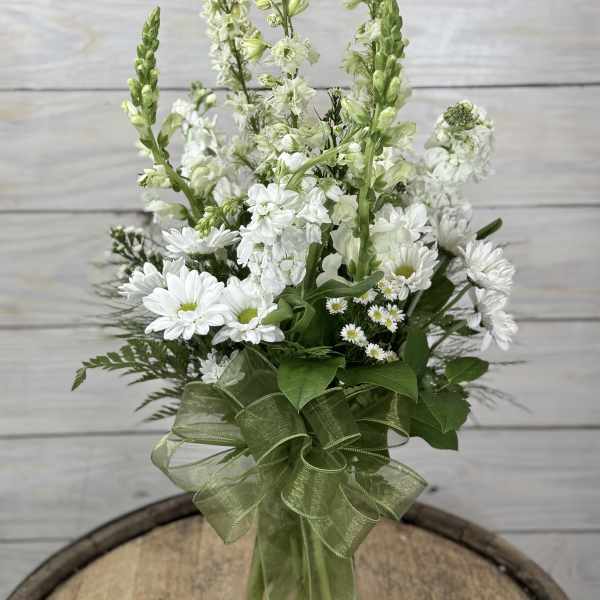 White floral bouquet with tall green spikes and a green ribbon wrap