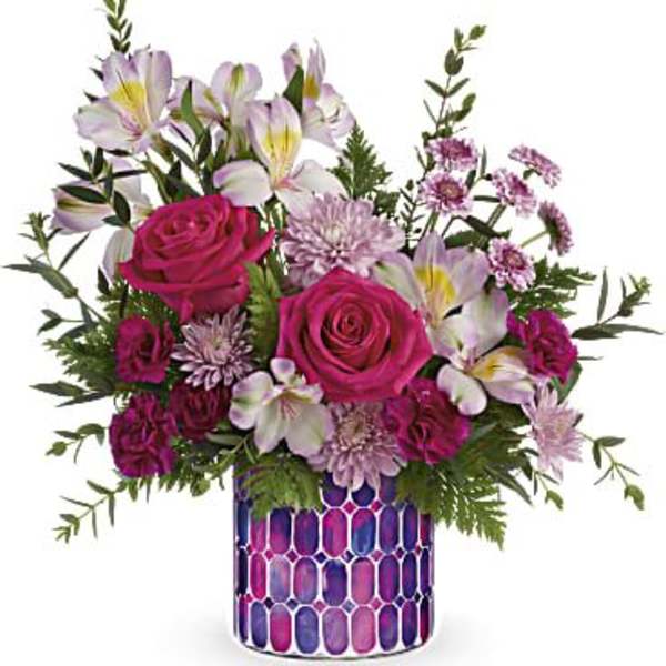 Pink roses and pale lilies in a patterned vase