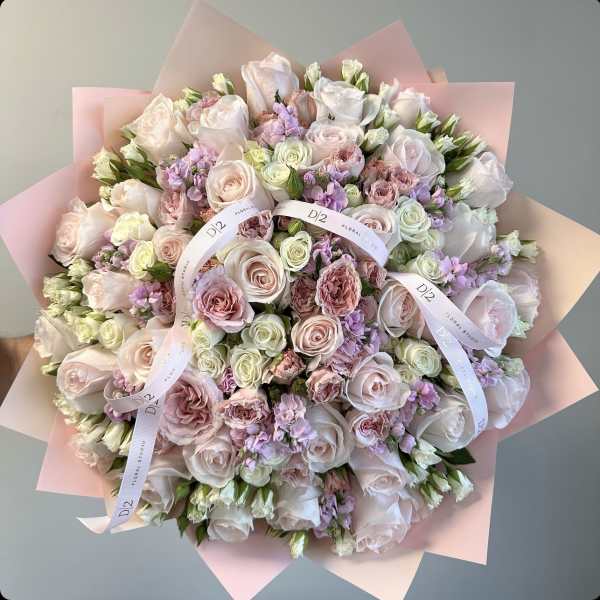 Large bouquet of pale pink and white roses with lavender accents