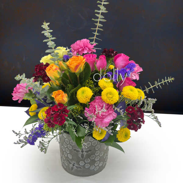 Mixed bouquet in a gray vase with pink, yellow, orange, and purple flowers