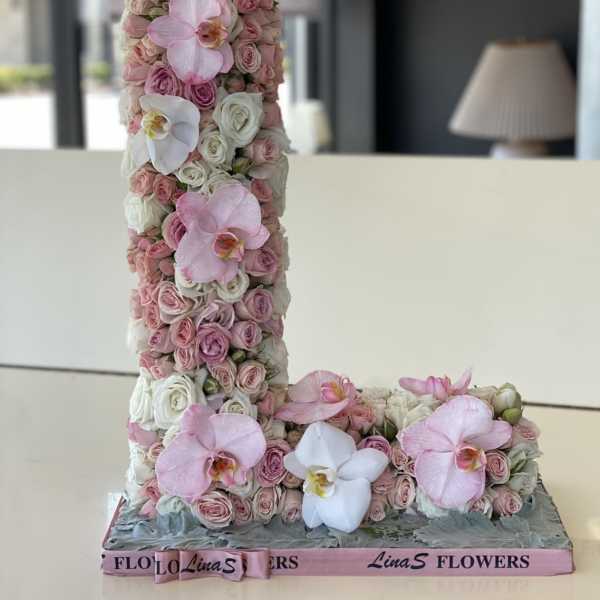 Pink and white floral letter arrangement with orchids and roses