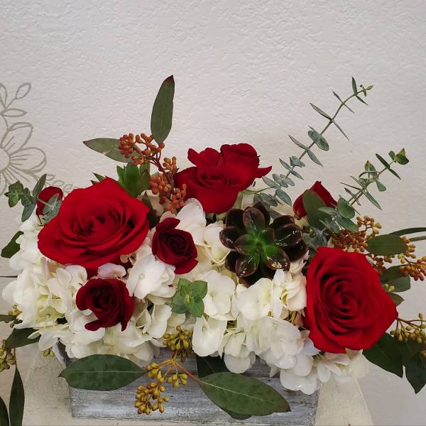 Red roses and white hydrangeas in a rectangular container