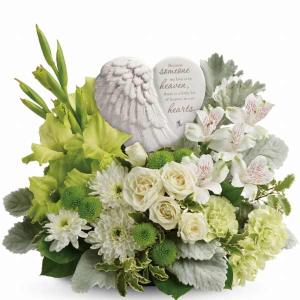 White sympathy bouquet with roses, lilies, and a memorial angel plaque