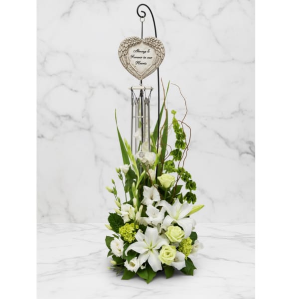 White floral sympathy arrangement with a heart memorial ornament