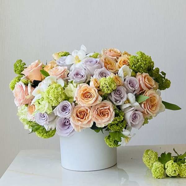 Pastel rose bouquet in a white box vase