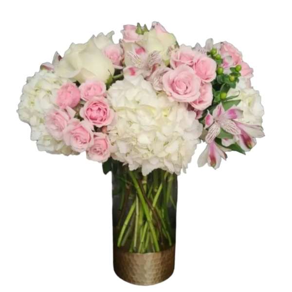 Pink and white bouquet in a tall glass vase