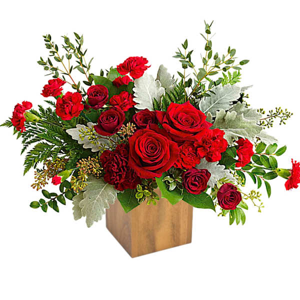 Red roses in a wooden cube vase with silver foliage