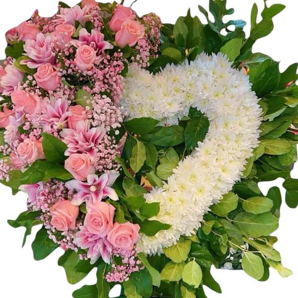 Pink and white floral standing wreath on a green easel