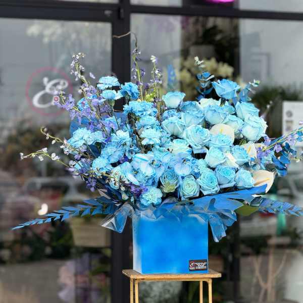Large blue rose arrangement in a square box