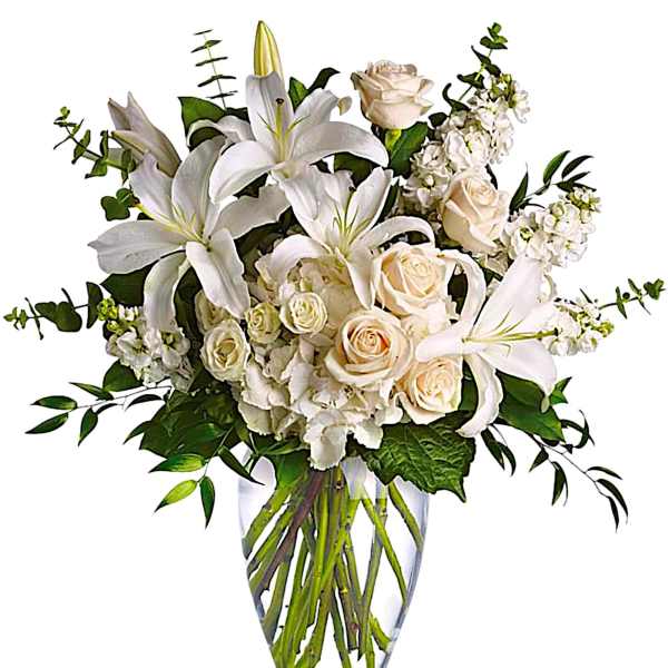 White lilies and cream roses in a clear glass vase
