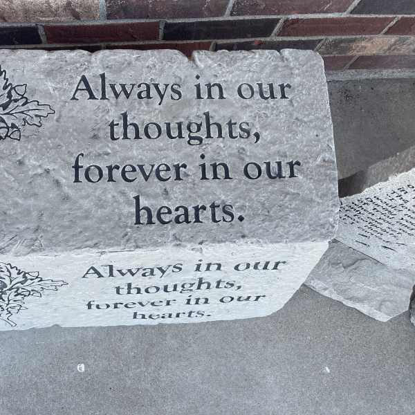 Memorial stone engraved with the words "Always in our thoughts, forever in our hearts."