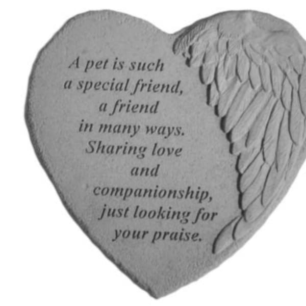 Heart-shaped stone plaque with engraved angel wing and memorial text