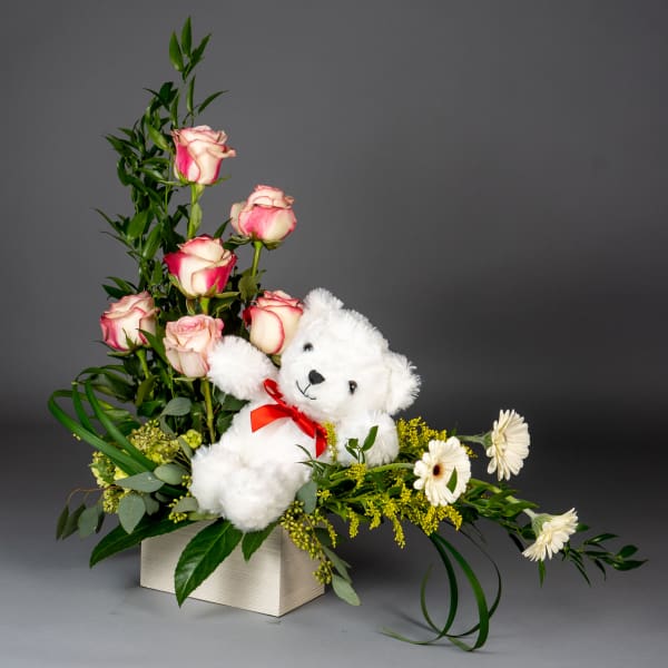 Pink roses with a white teddy bear in a rectangular box