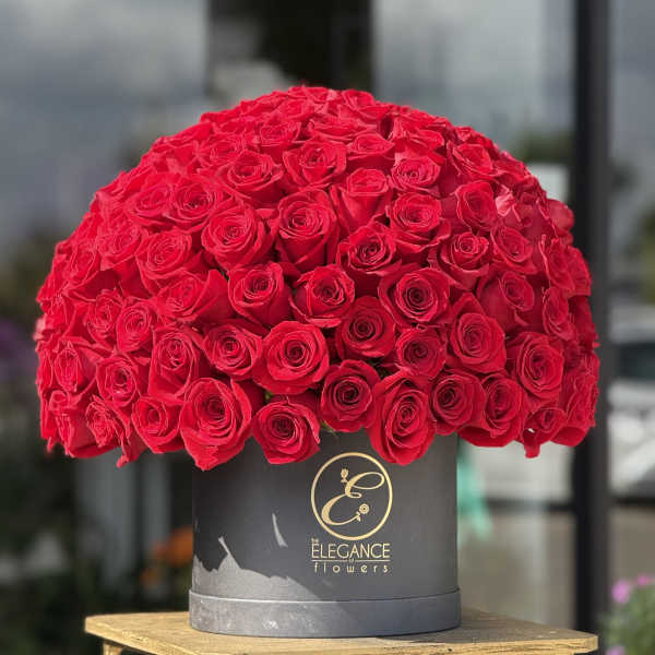 Large dome of red roses in a black hat box