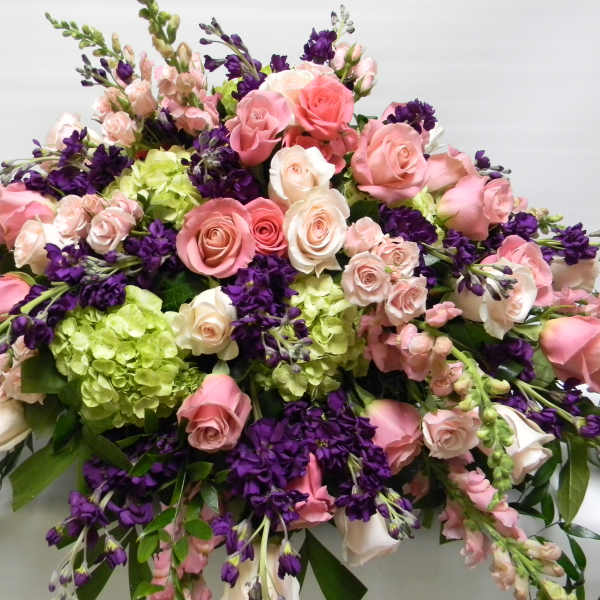 Large bouquet of pink and white roses with purple flowers