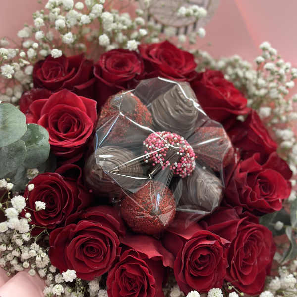 Bouquet of red roses with white baby's breath and chocolate-covered strawberries