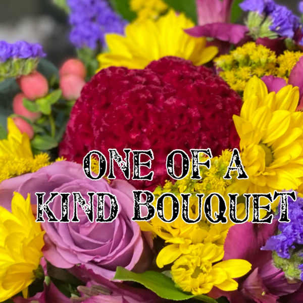 Colorful bouquet with roses, daisies, and purple filler flowers