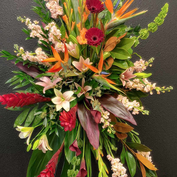 Large tropical floral spray with orange birds of paradise and red gerberas