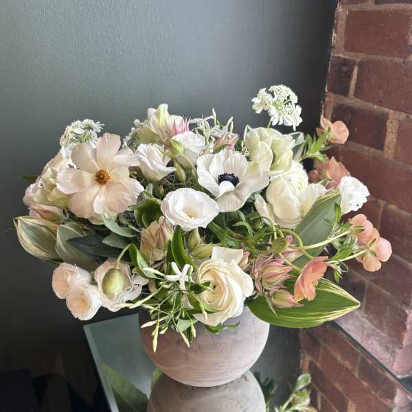 Soft pastel bouquet in a round ceramic vase