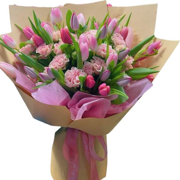 Bouquet of pink tulips and carnations wrapped in brown paper