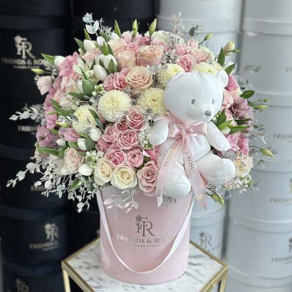 Pink and white rose bouquet with a teddy bear in a pink hatbox