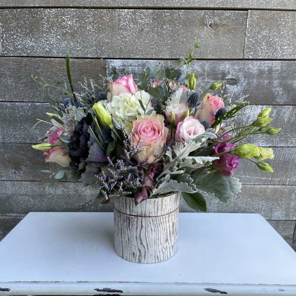 Mixed pink and white bouquet in a rustic wood-look container
