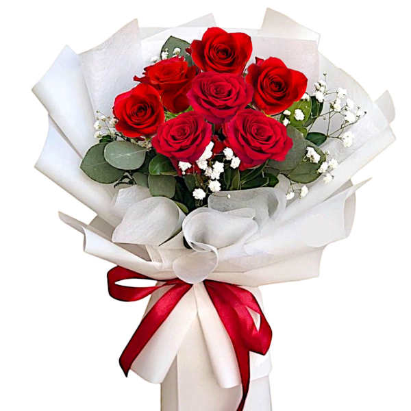 Bouquet of red roses wrapped in white paper with a red ribbon