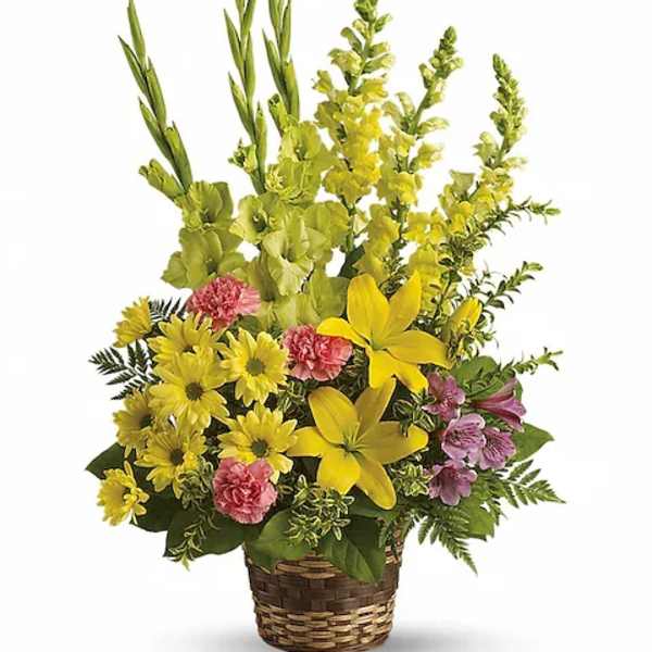 Yellow and pink mixed flower arrangement in a woven basket