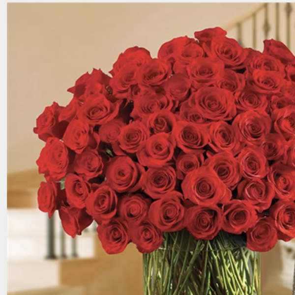 Large bouquet of red roses in a clear glass vase